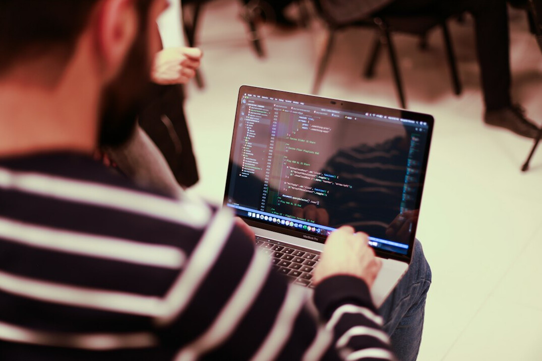 student learning coding on laptop